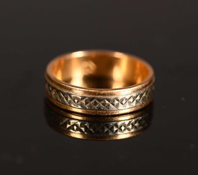 a close up of a gold ring on a black surface