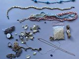 a lot of jewelry that is laying out on the table