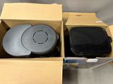 two boxes that have two black and one gray items in them