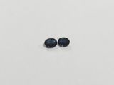 a pair of blue sapphires on a white surface