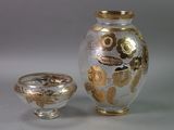 a vase and a bowl sitting next to each other on a table