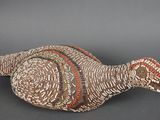 un gros plan sur une sculpture représentant un oiseau posée sur une surface noire
