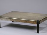 a coffee table with a metal top on a white surface