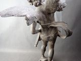 a statue of an angel with wings on a table
