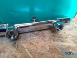 a close up of a metal pipe on a wooden surface