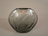a black and white vase sitting on a white surface