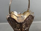 an antique silver plated basket with a handle and handles