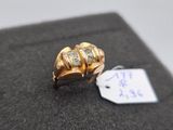 an image of a gold ring with three diamonds