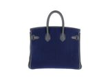 a blue and black handbag on a white background