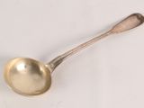 a silver spoon with a spoon handle on a white surface