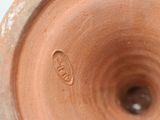 a close up of a brown vase with a hole in it