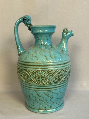 a blue vase that is sitting on a table