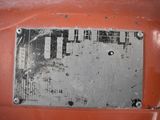 a close up of a metal plate on a rusted vehicle