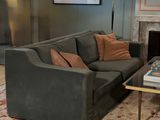 a living room with a couch, coffee table and a fireplace