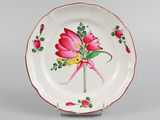 a white plate with a pink flower on it
