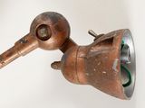 a rusted metal object on a white surface