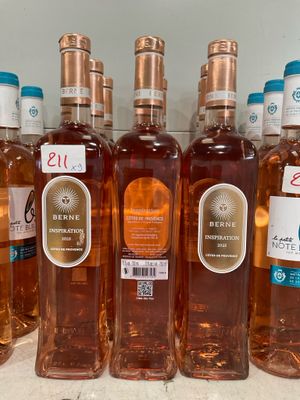 several bottles of wine are lined up on a shelf