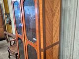 a wooden cabinet with glass doors in a room