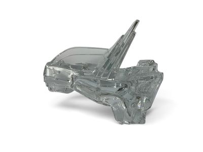 a glass model of a car on a white surface