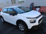 the white citrole is parked in front of a building
