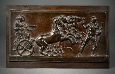 a bronze plaque with a horse and carriage on it