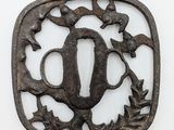 a metal plaque with a bird and a pitcher on it