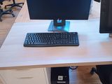 a computer desk with two monitors and a keyboard on it