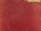 a red suitcase with a tag on it sitting on a table