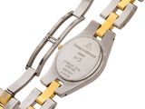 a close up of a watch on a white surface with a yellow band