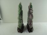 two figurines sitting on top of a white table