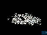 a close up of a bunch of diamonds on a black surface
