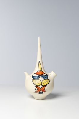 a white teapot with a colorful design on it