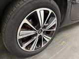 a close up of a tire on a car in a garage