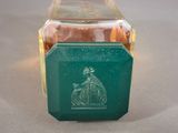 a green glass box with a picture of a woman on it