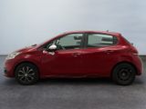 a red car is parked in a room with a white wall
