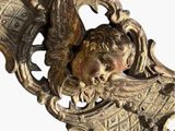 a gold statue of a woman with a bird on her head