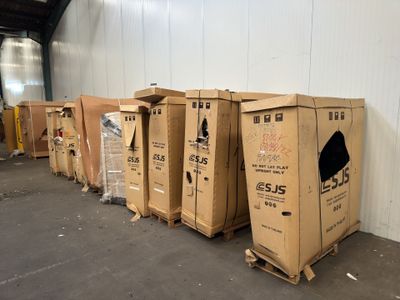 several cardboard boxes are lined up in a row in a warehouse