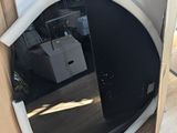 a microwave sitting inside of a cardboard box on the floor