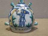 a blue and white vase with a picture of a man on it