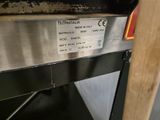 a close up of a metal shelf with a label on it