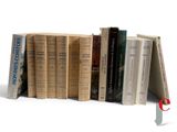 a lot of books that are stacked on top of each other