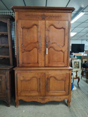 a large wooden cabinet in the middle of a room