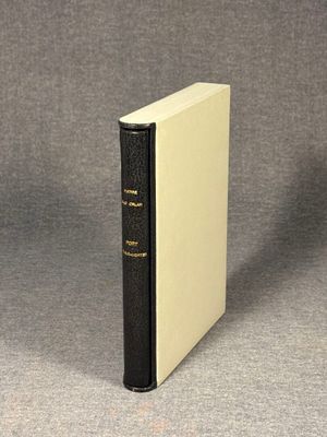 a black and white book sitting on top of a gray surface