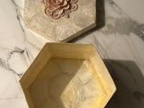 two boxes that are sitting on a marble table