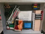 a metal box with a bunch of items in it