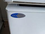 a white refrigerator with a blue sticker on it