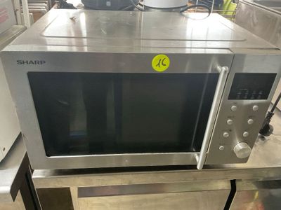 a microwave sitting on top of a table in a kitchen