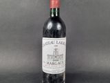 an old bottle of wine sitting on top of a table
