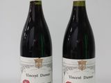 two bottles of wine sitting next to each other on a table