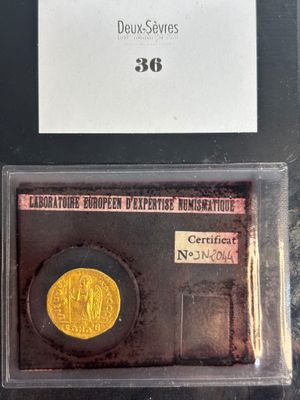 an image of a piece of gold coin with a label on it